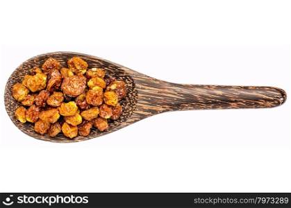 dried goldenberries on a wooden spoon isolated on white - superfruit