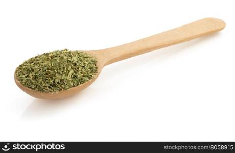 dried green spices in spoon isolated on white background