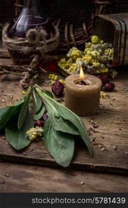 dried herbs for traditional medicine in the rural style.Selective focus. medicinal herb and burning candle