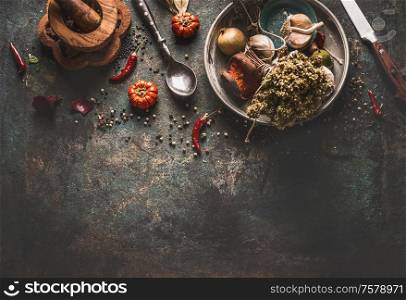Dried herbst and spices rustic food background with spoon and knife , top view.