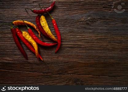 dried hot chili peppers on aged wood background