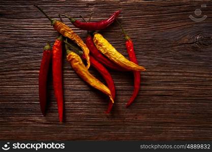 dried hot chili peppers on aged wood background