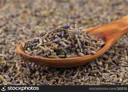 dried lavender organic tea in wooden spoon