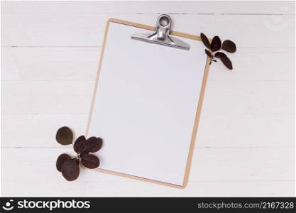dried leaves with white mock up clipboard