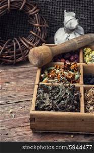 Dried medicinal herb. Dried medicinal herbs in wooden box on background of licorice