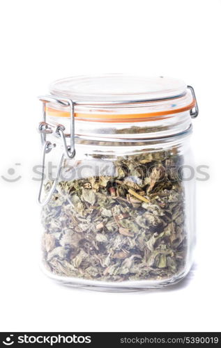Dried mint for tea in a glass jar isolated