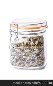 Dried mint for tea in a glass jar isolated