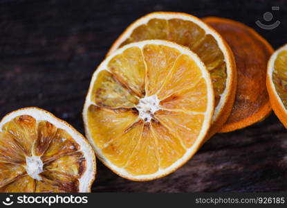 Dried orange slices on wooden dark background