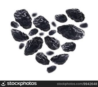 Dried plums in the shape of a heart on a white background.. Dried plums in the shape of a heart on a white background