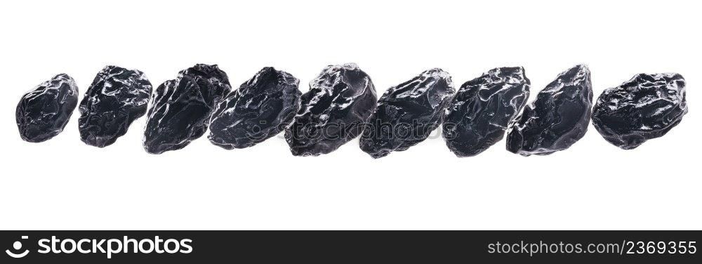 Dried prunes levitate on a white background.. Dried prunes levitate on a white background