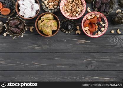 dried raw organic dates dried fruits nuts lukum baklava black wooden table