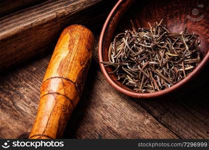 Dried rosemary leaves.Dried natural rosemary spice on old wooden background. Dried rosemary on wooden background