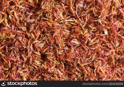 Dried safflower for herbal tea on background, dry safflower petals, Saffron substitute