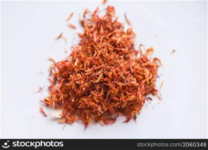 Dried safflower for herbal tea on white background, dry safflower petals, Saffron substitute