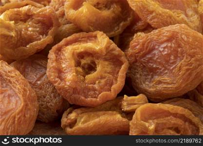 Dried small sour apricots close up full frame as background