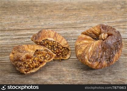 dried Turkish figs on a grained wood background