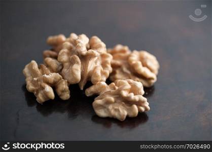 dried walnut without shell on a dark background