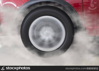 drifting and smoking wheel tire of new red car automobile