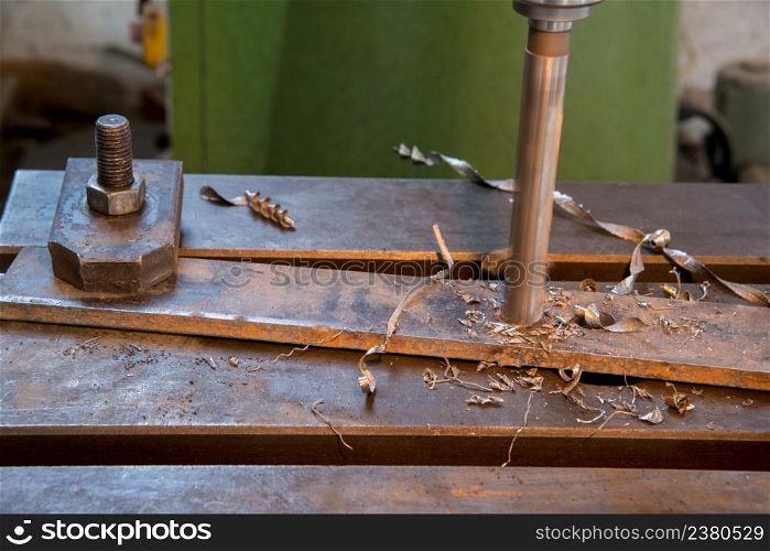 drilling of the metal plate, close up. drill machine closeup