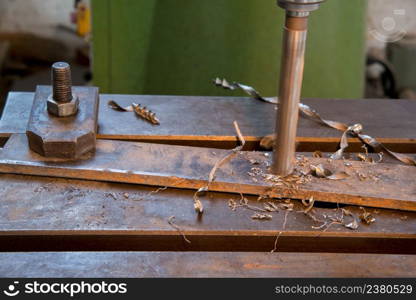 drilling of the metal plate, close up. drill machine closeup