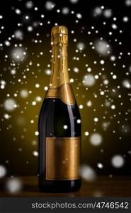 drink, alcohol, christmas, new year and winter holidays concept - bottle of champagne with blank golden label on wooden table over dark background and snow