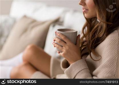 drink, christmas and hygge concept - close up of happy woman with cup of coffee in bed at home. close up of happy woman with cup of coffee at home