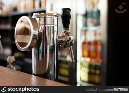 drink, equipment and object concept - close up of single tap chrome draft beer kegerator tower at bar or pub