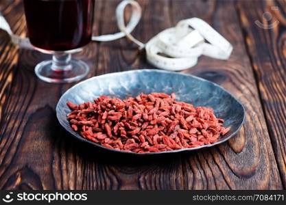 drink from goji and dry goji on a table