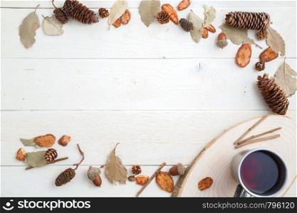 drink in a retro mug on a wooden background in the autumn style . top view with space for text