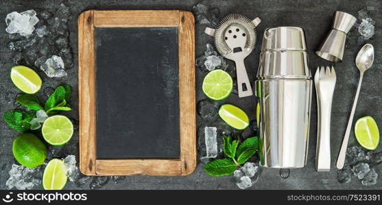 Drink making tools and ingredientsLime and mint leaves. Blackboard for recipe