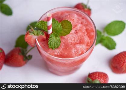Drink smoothies summer strawberry, Delicious strawberry smoothie garnished with fresh strawberry and mint in glass. soft focus. beautiful appetizer pink strawberry, well being and weight loss concept