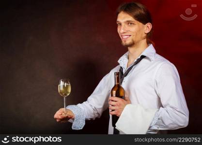 Drink winery liquor relax concept. Waiter serving wine bottle. Steward holds glass with alcohol beverage.. Waiter serving wine bottle.