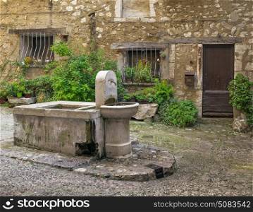 Drinking fountain in the square in a medieval French village