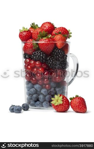 Drinking glass with healthy berries as a fruit shot on white background