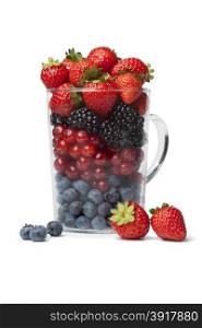 Drinking glass with healthy berries as a fruit shot on white background