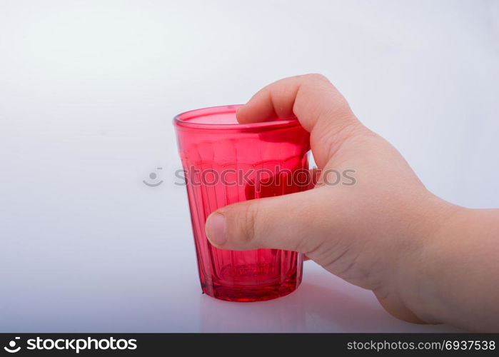 Drinking glasses of red color in hand with patterns