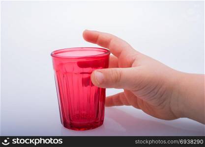 Drinking glasses of red color in hand with patterns