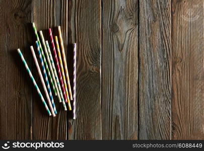 Drinking straws on wooden background