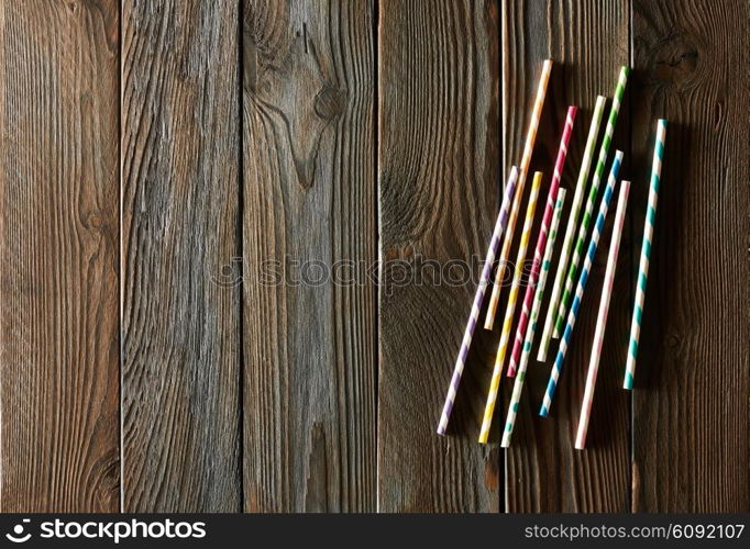 Drinking straws on wooden background