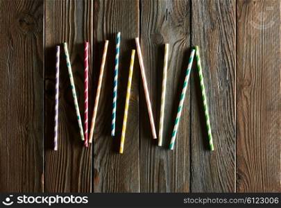 Drinking straws on wooden background