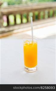 drinks and food concept - glass of fresh orange fruit juice at restaurant. glass of fresh orange fruit juice at restaurant