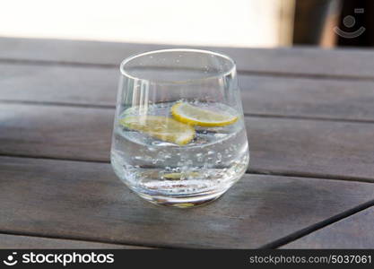 drinks and luxury concept - glass with cold water or cocktail on bar table. glass with cold water or cocktail on bar table