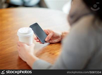 drinks, people, technology and lifestyle concept - close up of woman with smartphone and coffee at cafe. close up of woman with smartphone and coffee at cafe