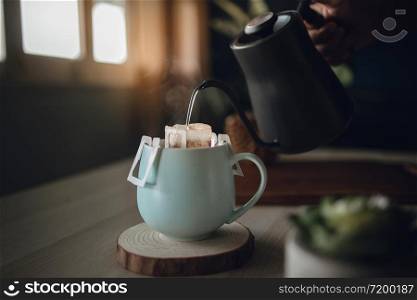 Dripping Coffee at Home in the Morning. Zen and Cozy Living. Pouring Hot Water from Kettle into a Coffee Cup. Sunlight through the Window