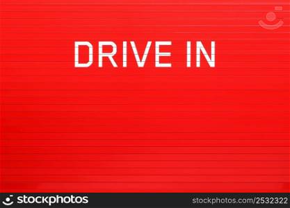Drive in sign on a red wall