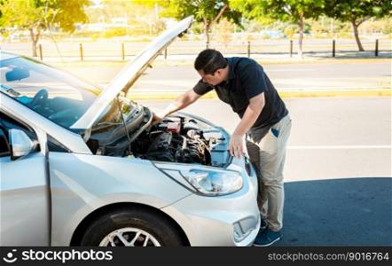 Driver checking the oil in his vehicle. Person checking the oil level of his car in the street. Driver inspecting car oil level