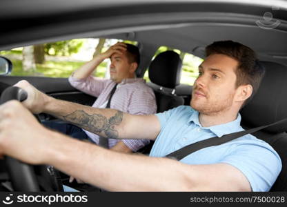 driver courses and people concept - driving school instructor talking to sad man failed exam in car. car driving instructor talking to man failed exam