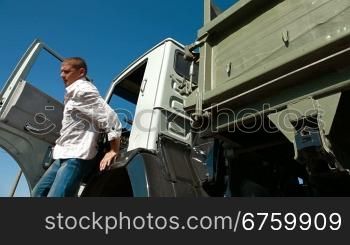 Driver Leaving Cab of Dump Truck
