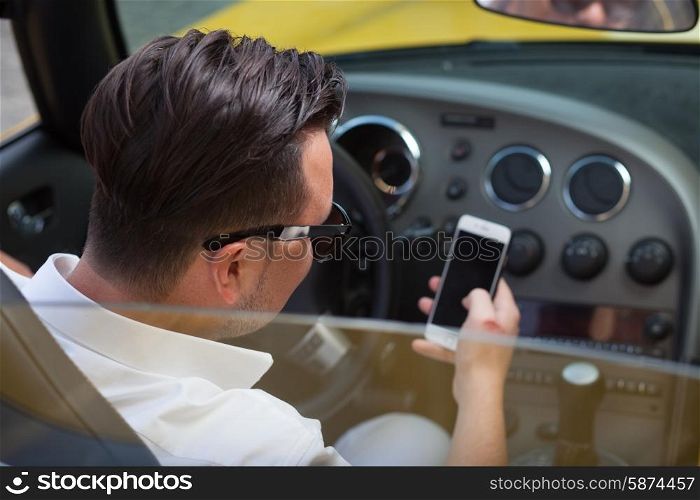 Driver man using smartphone in car