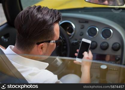 Driver man using smartphone in car